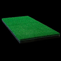Green artificial golf grass mat on a black background