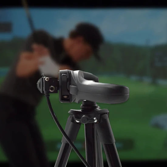 Camera on a tripod with a blurred background of two people and a scenic view.